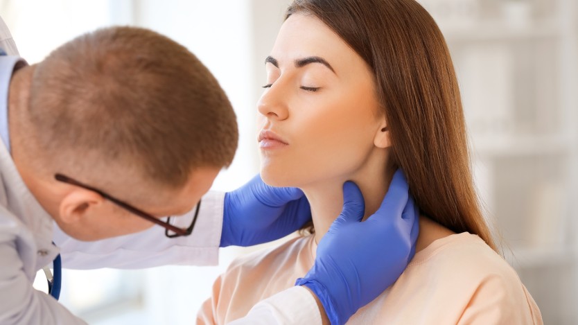 Doctor examining closely a patient's throat